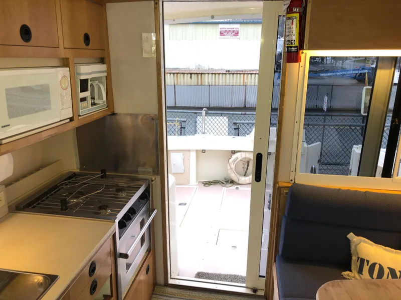 Slide: The Image of Interior of 2000 Albin 35 Tournament Express with kitchen and seating area. - 12