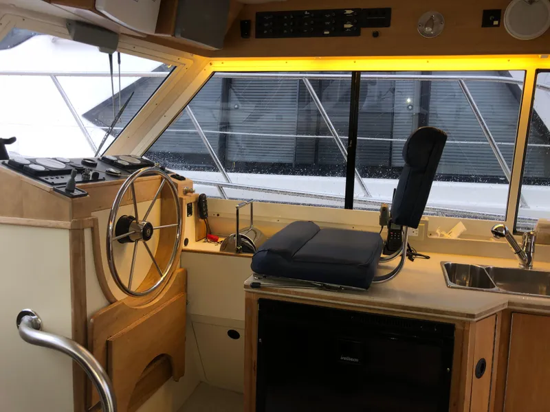 Slide: The Image of Interior of 2000 Albin 35 Tournament Express boat with helm, seating, and kitchenette. - 23