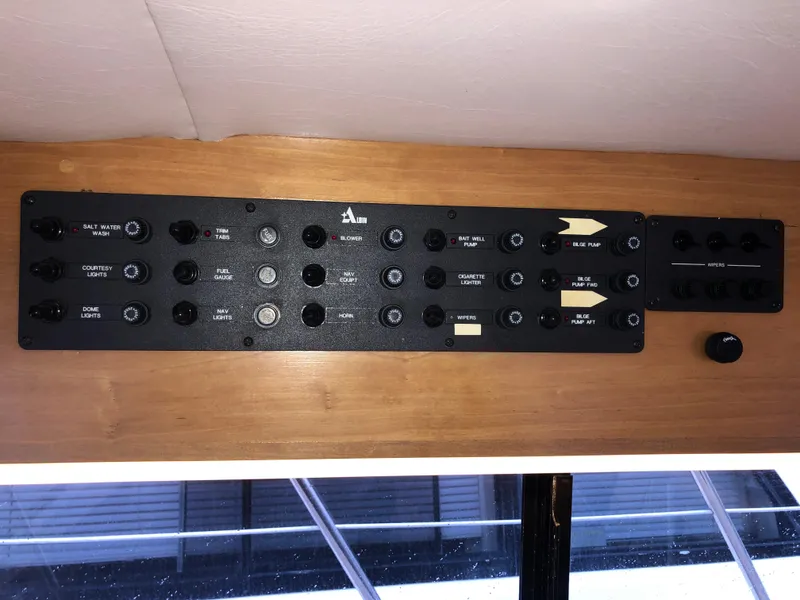 Slide: The Image of Control panel of a 2000 Albin 35 Tournament Express boat, featuring various switches and indicators. - 29