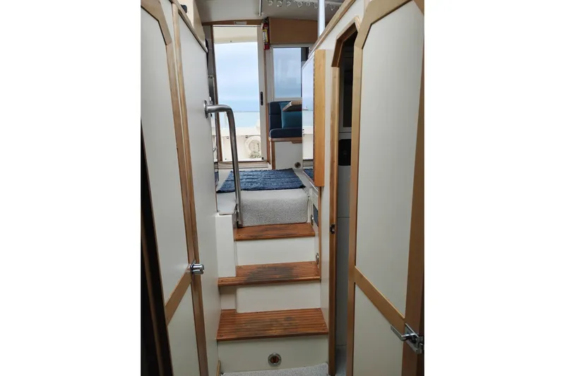 Slide: The Image of Interior view of 2000 Albin 35 Tournament Express boat with wooden steps and doors. - 37