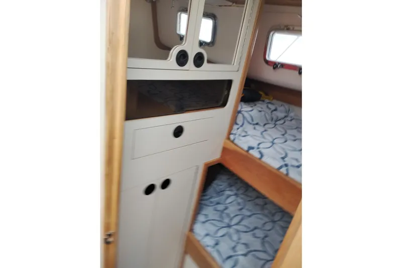 Slide: The Image of Interior of 2000 Albin 35 Tournament Express with bunk beds and storage cabinets. - 39