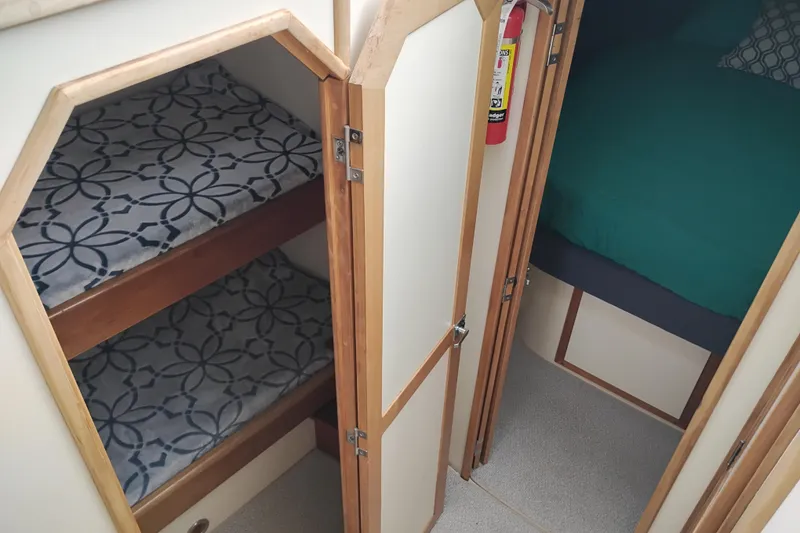 Slide: The Image of Interior of 2000 Albin 35 Tournament Express with bunk beds and a cozy cabin. - 40
