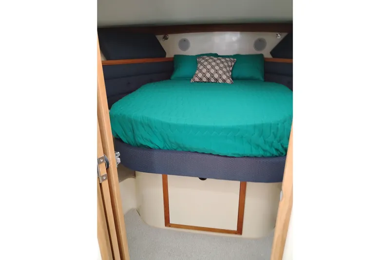 Slide: The Image of Cozy cabin interior of 2000 Albin 35 Tournament Express with teal bedding. - 41
