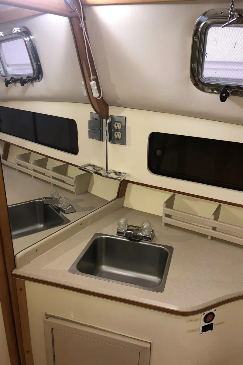 Slide: The Image of Interior of 2000 Albin 35 Tournament Express boat with sink and porthole. - 48