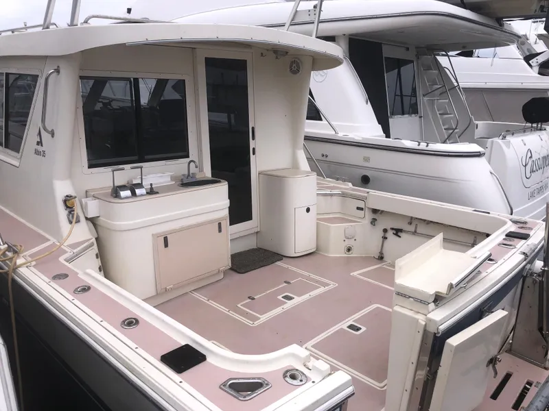 Slide: The Image of 2000 Albin 35 Tournament Express boat with spacious deck and sink, docked at marina. - 6