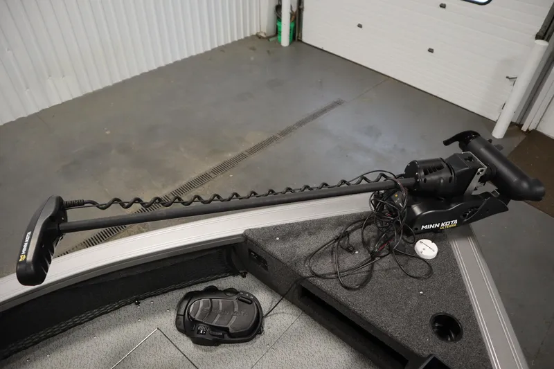 Slide: The Image of 2024 Crestliner 1950 Fish Hawk WT with Minn Kota trolling motor in a garage setting. - 13