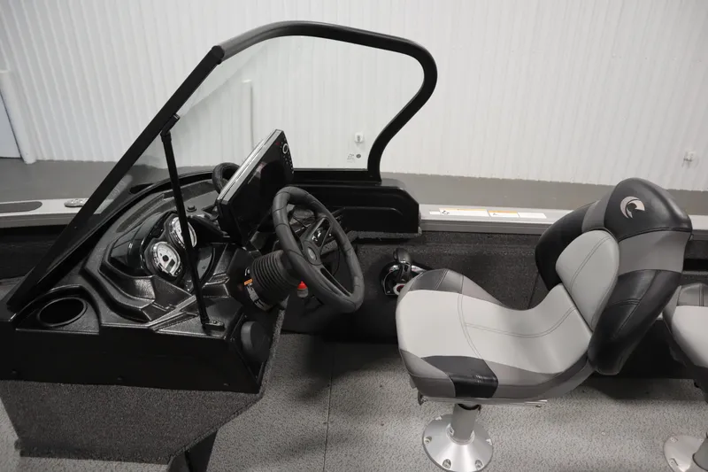 Slide: The Image of 2024 Crestliner 1950 Fish Hawk WT boat interior with steering wheel and seating. - 31