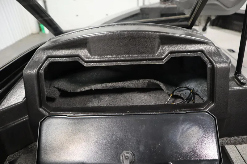 Slide: The Image of 2024 Crestliner 1950 Fish Hawk WT dashboard storage compartment, black interior, open lid. - 45