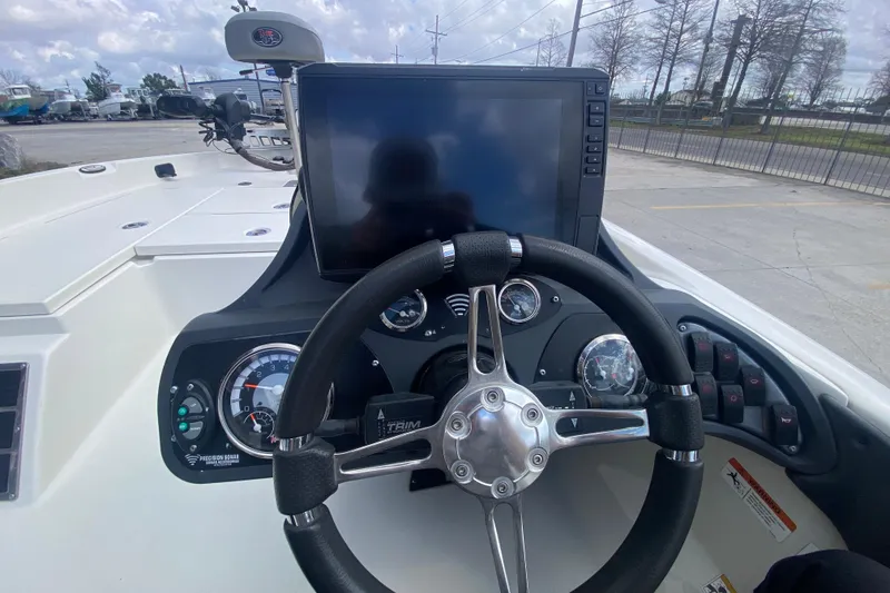 Slide: The Image of 2013 Ranger Z518 Intracoastal boat dashboard with steering wheel and navigation display. - 18