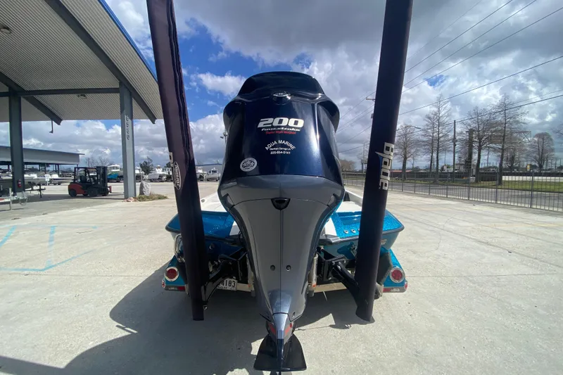 Slide: The Image of 2013 Ranger Z518 Intracoastal boat with powerful 200 HP engine, parked outdoors. - 5