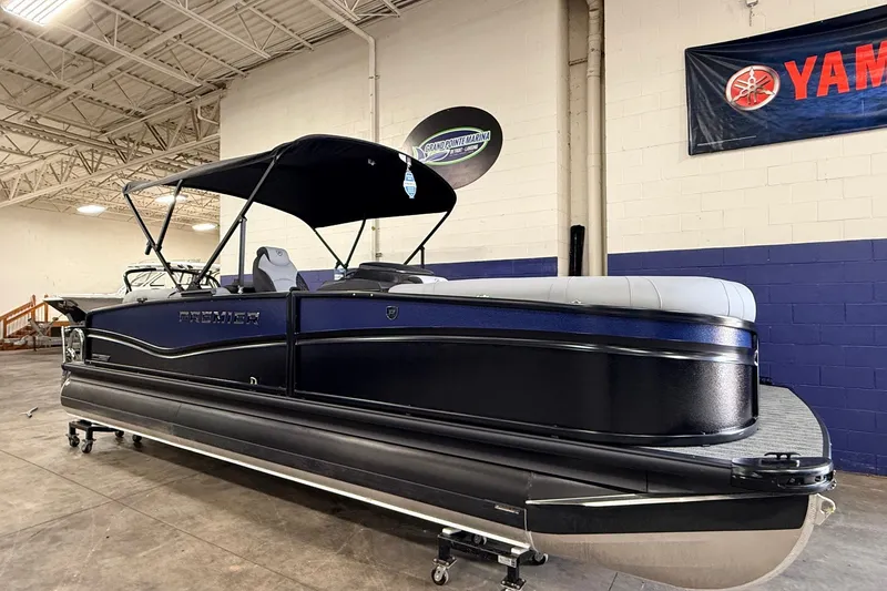 The Image of 2026 Premier 230 Solaris RF pontoon boat in showroom, featuring sleek design and canopy. - 0