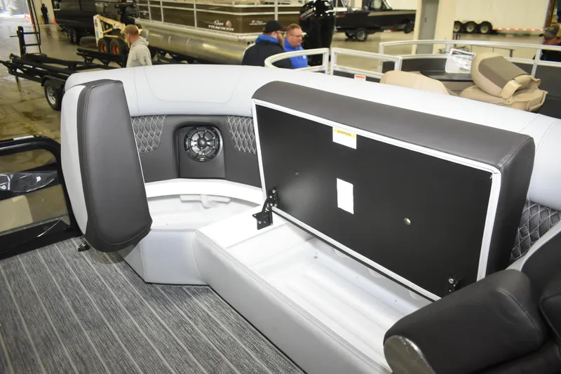 Slide: The Image of Interior of 2026 Premier 230 SOLARIS RF - PTX CL boat with open storage compartment. - 24