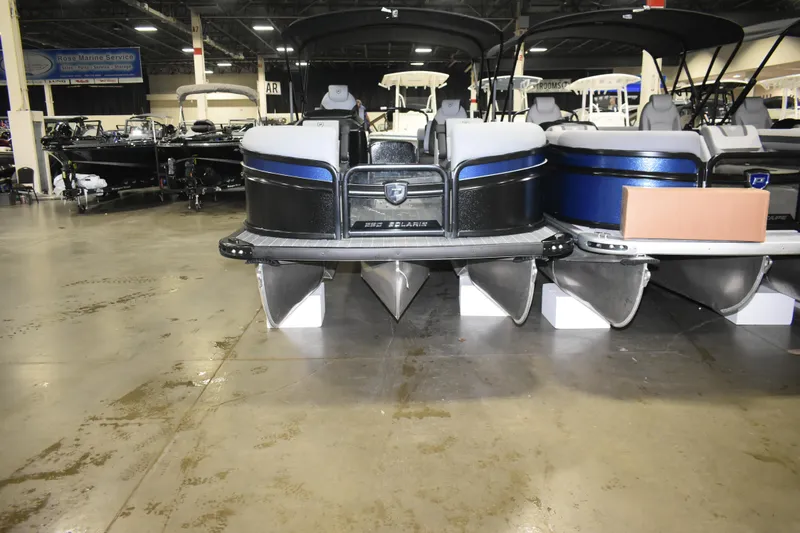 Slide: The Image of 2026 Premier 230 SOLARIS RF - PTX CL pontoon boats displayed indoors. - 3