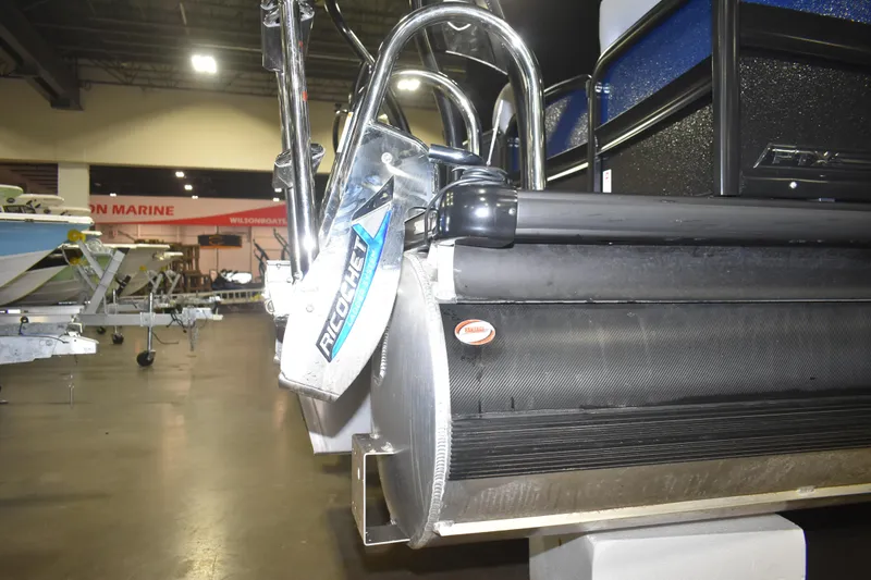 Slide: The Image of 2026 Premier 230 Solaris RF PTX CL pontoon boat displayed indoors. - 5