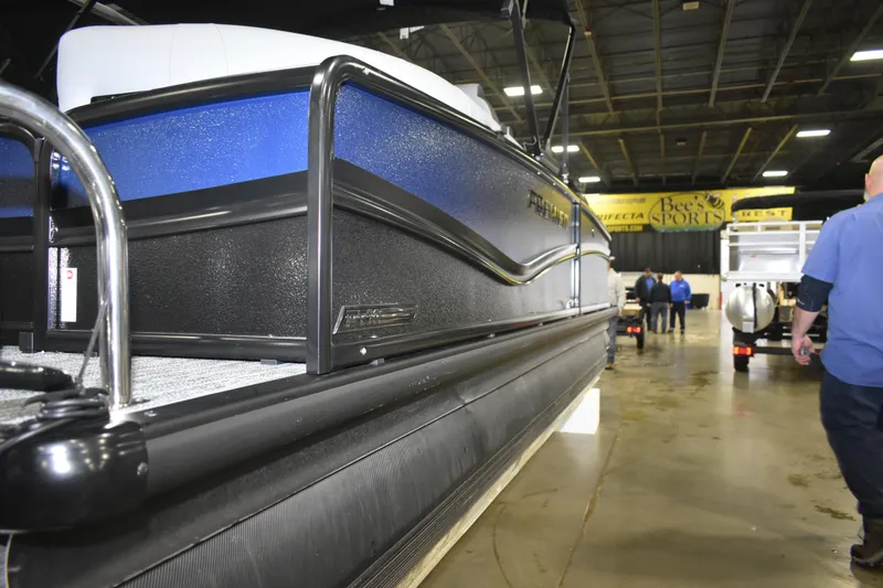 Slide: The Image of 2026 Premier 230 Solaris RF - PTX CL pontoon boat displayed indoors. - 6