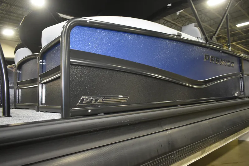 Slide: The Image of 2026 Premier 230 Solaris RF - PTX CL pontoon boat, blue and black design, indoor display. - 7