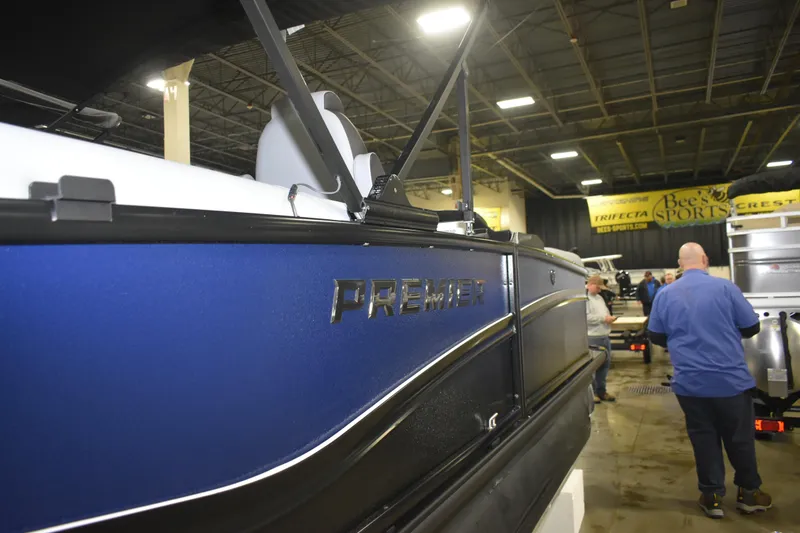 Slide: The Image of 2026 Premier 230 Solaris RF - PTX CL boat showcased indoors at a sports event. - 8