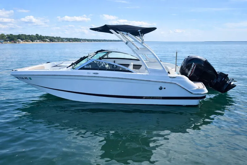 Slide: The Image of 2021 Four Winns HD1 OB boat on calm water with outboard motor. - 1