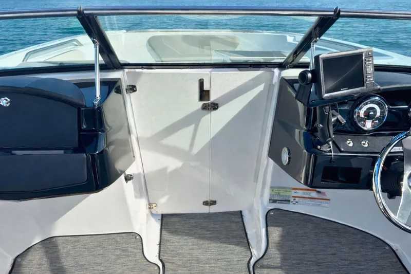 Slide: The Image of 2021 Four Winns HD1 OB boat dashboard with steering wheel and navigation system. - 12