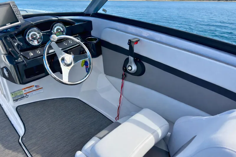 Slide: The Image of 2021 Four Winns HD1 OB boat interior with steering wheel and dashboard controls. - 16