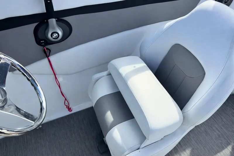 Slide: The Image of 2021 Four Winns HD1 OB boat interior with steering wheel and cushioned seat. - 18