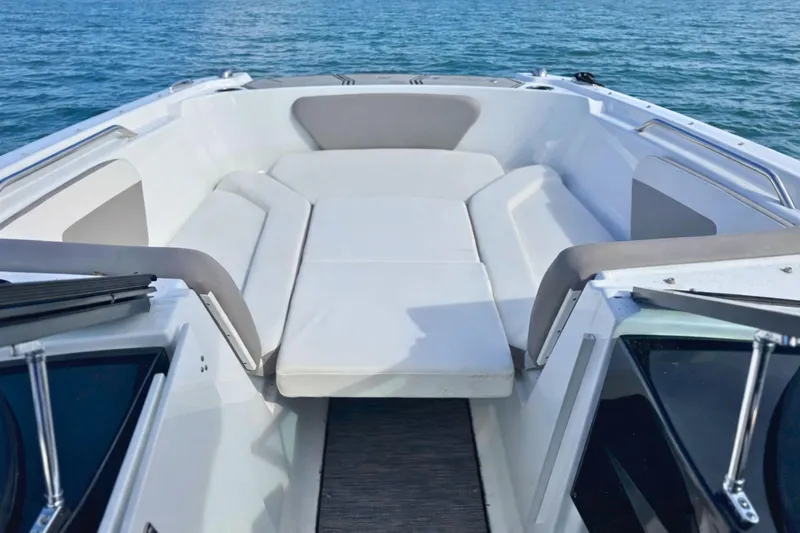 Slide: The Image of 2021 Four Winns HD1 OB boat interior with spacious seating on calm water. - 21