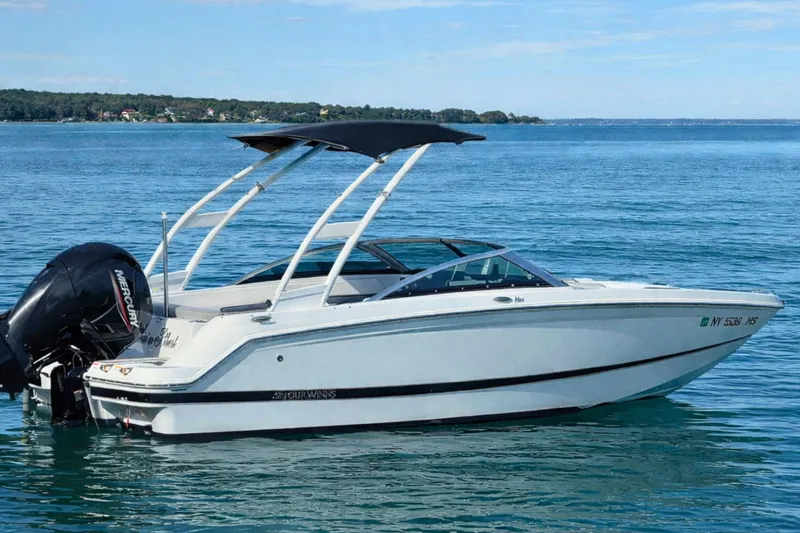 Slide: The Image of 2021 Four Winns HD1 OB boat on calm blue water with scenic background. - 3