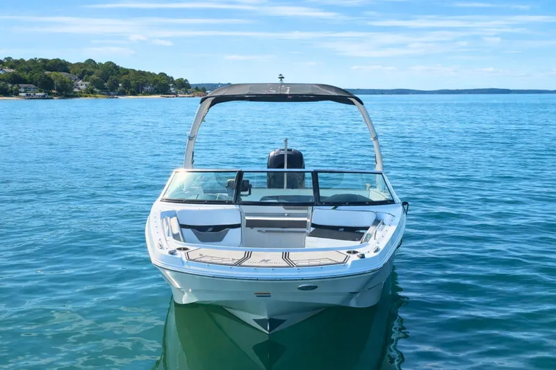 Slide: The Image of 2021 Four Winns HD1 OB boat on calm blue water, clear sky background. - 4