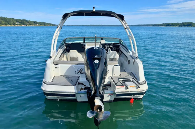 Slide: The Image of 2021 Four Winns HD1 OB boat on calm blue water, rear view. - 5