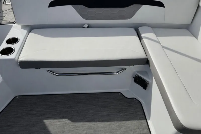 Slide: The Image of 2021 Four Winns HD1 OB boat interior seating with cup holders and sleek design. - 8