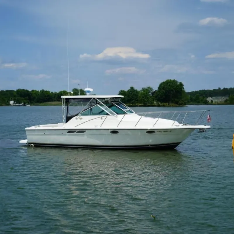 The Image of 2004 Tiara Yachts 2900 Open Classic boat on a calm lake with trees in the background. - 0