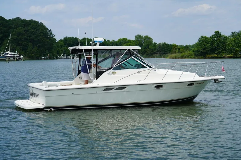 Slide: The Image of 2004 Tiara Yachts 2900 Open Classic cruising on a serene lake. - 10