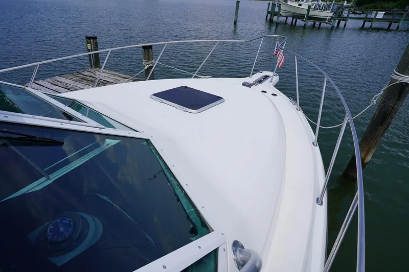 Slide: The Image of 2004 Tiara Yachts 2900 Open Classic docked, showcasing sleek design and spacious deck. - 17