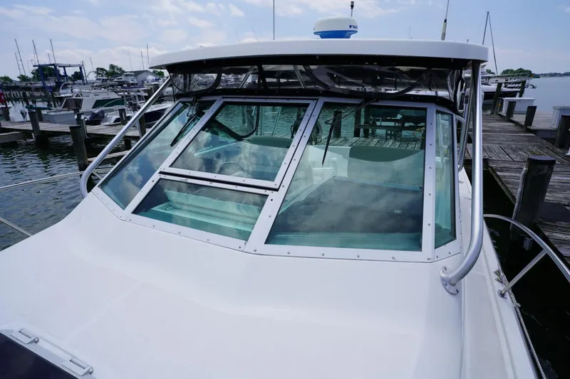 Slide: The Image of 2004 Tiara Yachts 2900 Open Classic docked at marina, front view. - 19