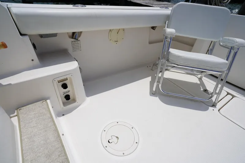 Slide: The Image of 2004 Tiara Yachts 2900 Open Classic deck with chair and storage compartments. - 23