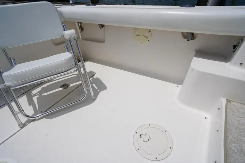 Slide: The Image of 2004 Tiara Yachts 2900 Open Classic deck with white seating and clean surface. - 24
