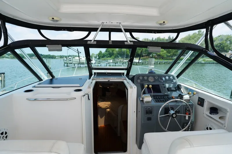 Slide: The Image of 2004 Tiara Yachts 2900 Open Classic cockpit with steering wheel and navigation controls. - 26