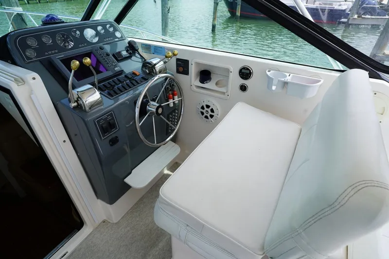Slide: The Image of 2004 Tiara Yachts 2900 Open Classic helm with steering wheel and controls. - 28