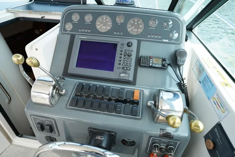 Slide: The Image of Helm of 2004 Tiara Yachts 2900 Open Classic with navigation controls and instruments. - 30