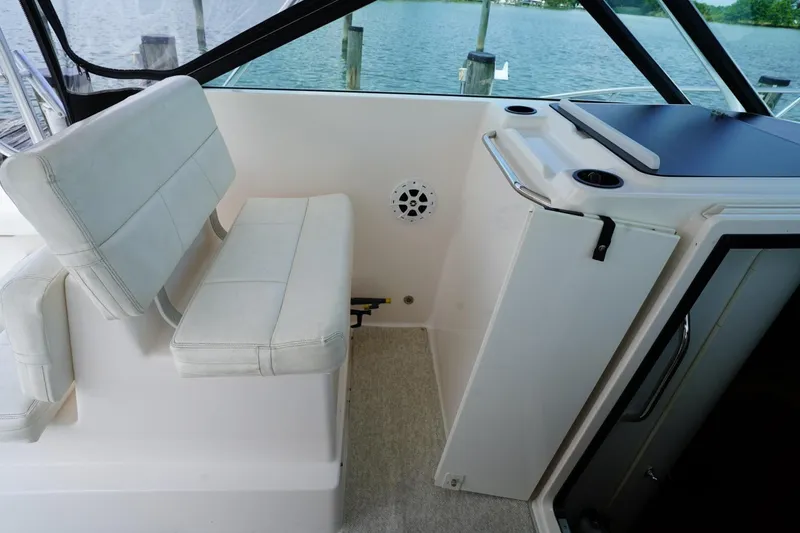 Slide: The Image of 2004 Tiara Yachts 2900 Open Classic interior with seating and water view. - 32