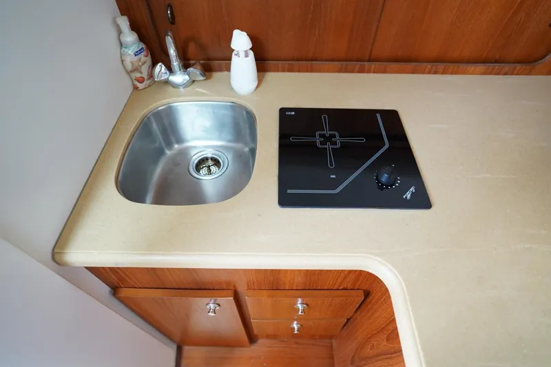 Slide: The Image of 2004 Tiara Yachts 2900 Open Classic galley with sink and stove. - 36