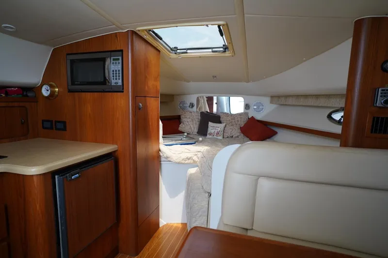 Slide: The Image of Interior of 2004 Tiara Yachts 2900 Open Classic, featuring cozy cabin and kitchenette. - 39