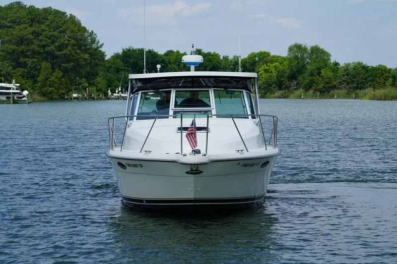 Slide: The Image of 2004 Tiara Yachts 2900 Open Classic boat on a serene lake. - 4