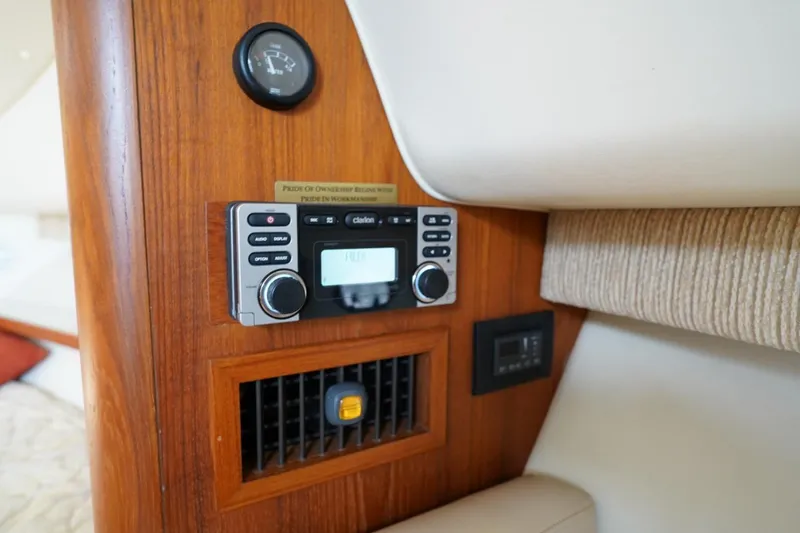 Slide: The Image of 2004 Tiara Yachts 2900 Open Classic interior with control panel and wood finish. - 42