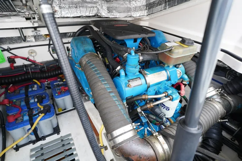 Slide: The Image of Engine compartment of 2004 Tiara Yachts 2900 Open Classic, featuring blue engine and batteries. - 48