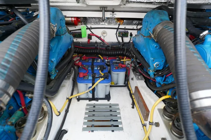 Slide: The Image of Engine compartment of 2004 Tiara Yachts 2900 Open Classic, featuring dual blue engines. - 50