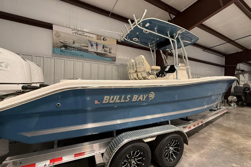 Slide: The Image of 2026 Bulls Bay 255 Center Console boat on trailer in indoor showroom. - 12