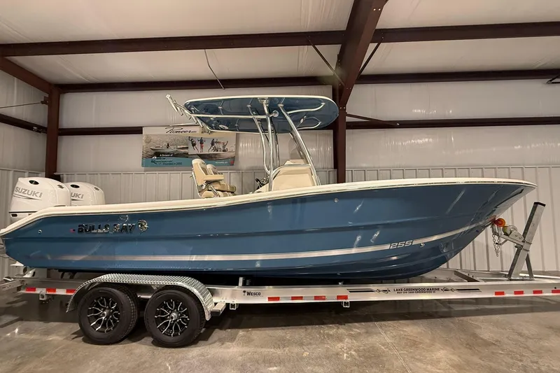 Slide: The Image of 2026 Bulls Bay 255 Center Console boat on trailer in indoor storage. - 13