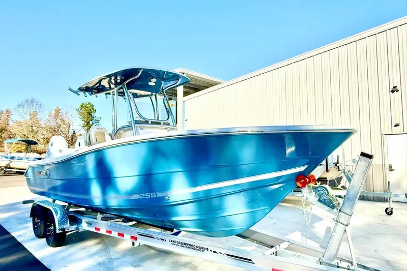Slide: The Image of 2026 Bulls Bay 255 Center Console boat on trailer, vibrant blue finish. - 2