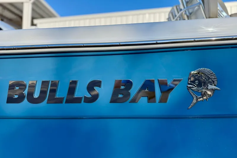 Slide: The Image of 2026 Bulls Bay 255 Center Console boat with blue hull and fish emblem. - 3